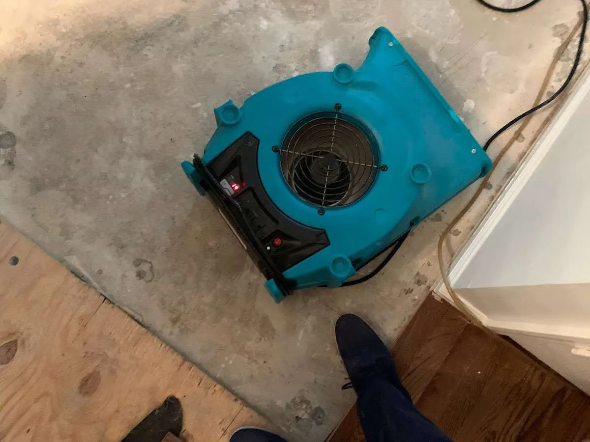 Air mover drying subfloor during Leak Detection & Repair in Scarsdale